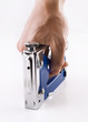 Staple gun in man's arm over white