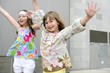 Two little girls dancing in the city