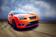 Beautiful orange sport car on road