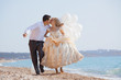 Wedding couple running on beach