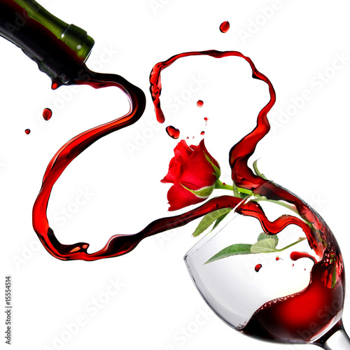 Heart from pouring red wine in goblet with red rose Heart from pouring red wine in goblet with red rose