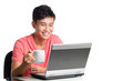 Photo: Young Asian Chinese using laptop and having a drink Young Asian Chinese using laptop and having a drink