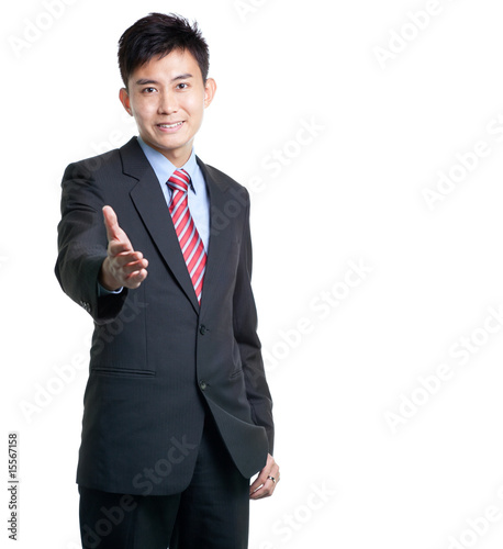 Photo: Asian Chinese businessman stretches out his arm for handshake Asian Chinese businessman stretches out his arm for handshake