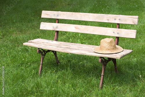 Photo: bench on grass with hat bench on grass with hat