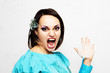 Angry young woman with fly swatter in her hand