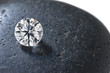 Close up of a diamond on the black stone Close up of a diamond on the black stone