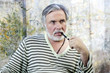 Portrait of a mature man smoking tobacco pipe
