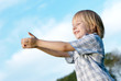 The little boy with stretched hands to sky