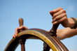 Hands on ship rudder.
