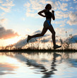 Silhouette woman run under blue sky with clouds