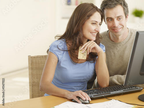 Photo: Couple shopping online with a credit card Couple shopping online with a credit card