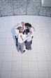 Aerial view of six office workers huddling together