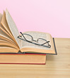 Glasses on open book