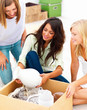 Happy three young girls unpacking a white jar