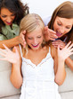Young women with a happy surprised girl looking at a gift
