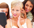 Closeup of beautiful young women looking into a mirror