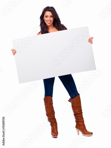 Happy young girl holding a white board isolated on white