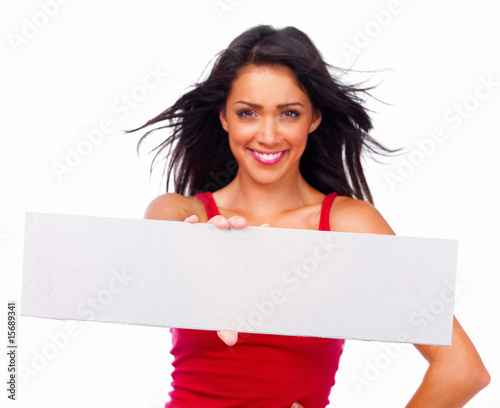 Photo: Portrait of a happy beautiful woman holding a white board Portrait of a happy beautiful woman holding a white board
