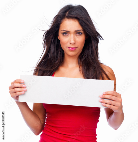 Photo: Portrait of a smiling beautiful woman holding a white board Portrait of a smiling beautiful woman holding a white board