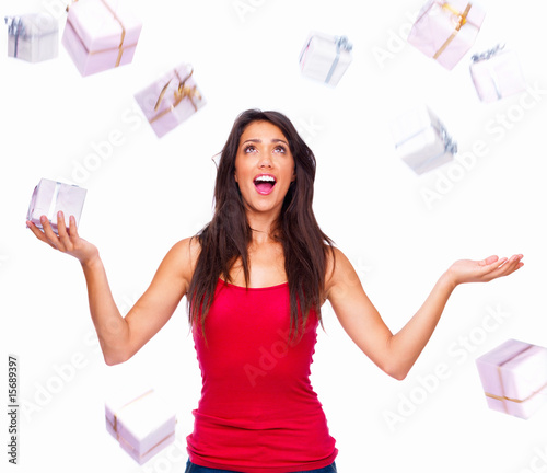 Foto: Portrait of a beautiful girl with gifts isolated on white Portrait of a beautiful girl with gifts isolated on white