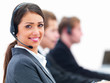 Closeup of a smiling young business woman with headphones and pe