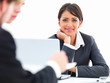 Business people in a meeting with focus on a smiling woman in th