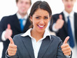 Portrait of happy young businesswoman showing thumbs up sign