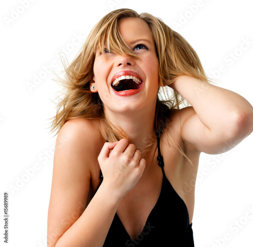 Foto: Attractive young woman with hand in hair, laughing. Attractive young woman with hand in hair, laughing.