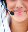 Closeup of a young beautiful business woman using headphones