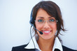 Closeup of a young beautiful business woman using headphones