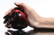 a hand holding a dirty apple