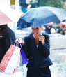 Beautiful happy woman holding umbrella