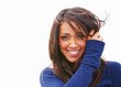 Closeup of a young woman smiling against white background