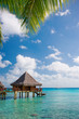 resort bungalow over rtuquoise water in tahiti