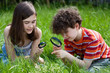 Kids looking through magnifying glass Kids looking through magnifying glass