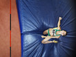 Athlete on a crash mat after high jumping