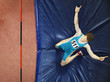 Athlete on a crash mat after high jumping