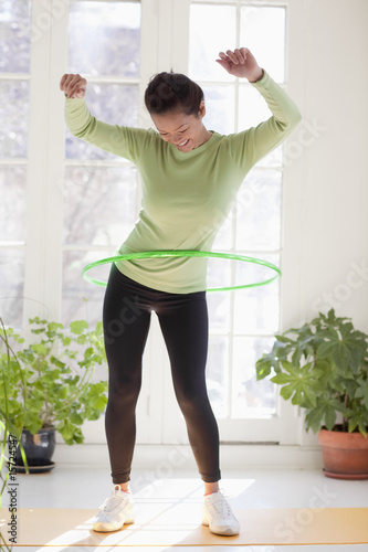 Photo: Woman exercising with hula hoop Woman exercising with hula hoop