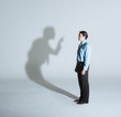 Man being scolded by his shadow