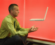 Man with floating laptop over him