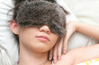 Young lady sound asleep with night eyeshades on