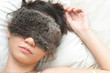 Young lady sound asleep with night eyeshades on