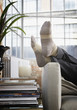 Man's feet up on arm of couch in modern home