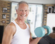 Man lifting dumbbells in living room