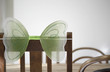 Empty chair with butterfly decor on back