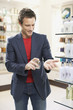Man testing cologne in store