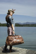 Woman standing on dock with large bag