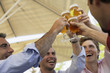 Four men toasting outdoors