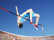 Athlete high jumping in an arena