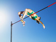 Athlete high jumping in an arena